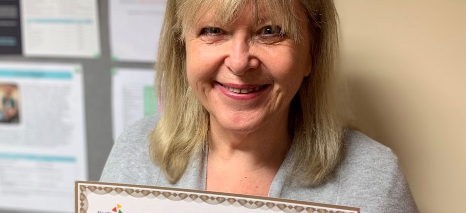 Pictures shows veterinary receptionist Sheila Potter holding her gold British Veterinary Receptionist Association Award